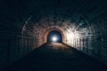 Dark creepy abandoned underground tunnel or vault corridor in bomb shelter and man with flashlight, abstract light in end concept