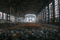 Dark creepy ruins of demolished abandoned large industrial warehouse or hangar of Soviet factory Royalty Free Stock Photo