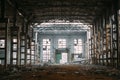 Dark creepy ruins of demolished abandoned large industrial warehouse or hangar of Soviet factory Royalty Free Stock Photo