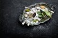 Dark culinary background with bay leaves, salt, pepper and garlic, view from above, copy space for recipe text