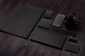 Dark deluxe black branding stationery, mockup scene with phone, coffee on black wooden plank. Royalty Free Stock Photo