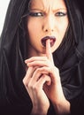 Dark demon in black hood. Death coming for soul. Woman devil in black hood. Royalty Free Stock Photo