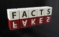 Dark dice with word facts and mirrored word fakes Royalty Free Stock Photo