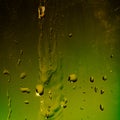 Dark dirty green background with a flow of liquid