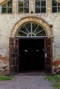 Dark doorway with wooden doors on old brick building