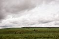 Dark dramatic rainy sky clouds over agricultural rural landscape