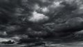 dark dramatic sky with black stormy clouds before rain or snow as abstract background, extreme weather, the sun shines through the Royalty Free Stock Photo