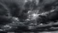 dark dramatic sky with black stormy clouds before rain or snow as abstract background, extreme weather, the sun shines through the Royalty Free Stock Photo