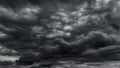 dark dramatic sky with black stormy clouds before rain or snow as abstract background, extreme weather, the sun shines through the Royalty Free Stock Photo