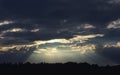 Dark Dramatic Sky with Sunbeams Through Storm Clouds Royalty Free Stock Photo