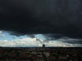 Dark and Dramatic Storm Over Mulhouse: A Lurid Dance of Black and White Clouds under Blue Sky Above the Towering City of Mulhouse Royalty Free Stock Photo