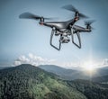Dark drone flying above mountains. Royalty Free Stock Photo