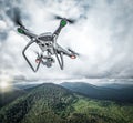 Dark drone flying above mountains. Royalty Free Stock Photo