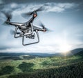 Dark drone flying above mountains. Royalty Free Stock Photo