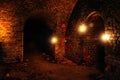 Dark dungeon under the old German fortress illuminated by candles Royalty Free Stock Photo