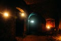 Dark dungeon under the old German fortress illuminated by candles