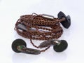 Dark earbud with brown cable