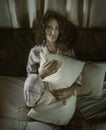 Dark and edgy portrait of depressed and sleepless latin woman lying worried and awake on bed at night suffering insomnia and Royalty Free Stock Photo