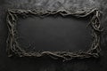 Dark, eerie frame made of intertwined roots creates a mysterious and captivating border on a textured black background Royalty Free Stock Photo