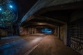 Dark empty dirty grunge underground concrete tunel with a road during mystic night with blue street Royalty Free Stock Photo