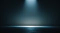 Dark empty studio background with soft blue spotlight, subtle fog, and cinematic gradient lighting. Royalty Free Stock Photo