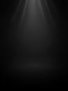 A dark, empty studio or stage background with soft, diffused white light beams emanating from the center, creating a spotlight Royalty Free Stock Photo