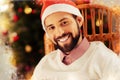Dark-eyed bearded man feeling extremely cheerful before celebrating New year