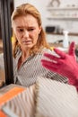 Dark-eyed housewife having allergic reaction to dust at home Royalty Free Stock Photo