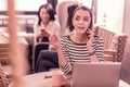 Dark-eyed woman calling her best friend inviting her for evening party at her home Royalty Free Stock Photo