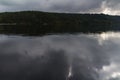 Dark fall trees in czech landscape on dam Rimov with dramatic sky