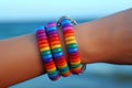 Dark female hands with a colorful bracelet