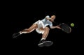 Female professional tennis player in action, motion isolated on black background, look from the bottom. Concept of sport Royalty Free Stock Photo