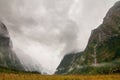 Dark and foggy Fiordland valley, water falls from misty mountains, Milford Track New Zealand Royalty Free Stock Photo