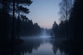 Dark forest lake at twilight with mist and tree reflections in deep blue light dusk Royalty Free Stock Photo