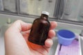 Dark glass bottle in hand laboratory worker. Royalty Free Stock Photo