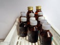 Dark glass bottles with antiseptics, herbal tinctures and other liquid medicines are on the shelf. Medical background