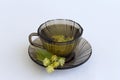 Dark glass cup with herbal hot linden tea with bloom flowers of linden Royalty Free Stock Photo