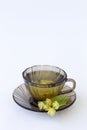 Dark glass cup with herbal hot linden tea with bloom flowers of linden Royalty Free Stock Photo