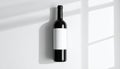 Dark glass wine bottle with blank white label on white surface with light shadows liquid Royalty Free Stock Photo