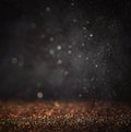 Dark glitter vintage lights background. light gold and black. defocused. Royalty Free Stock Photo