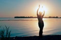 Silhouette of slim woman illuminated with sunshine dancing traditional tribal belly dance