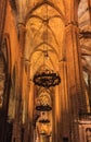 Dark gothic cloister with ornate metal chandeliers in the Cathedral of the Holy Cross and Saint Eulalia, or Barcelona Cathedral i