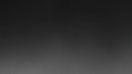 A dark and grainy texture background with a gradient effect transitioning from black to gray tones creating a subtle and abstr Royalty Free Stock Photo