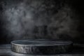 Dark graphite podium positioned at an angle against a black background with a moody atmosphere Royalty Free Stock Photo