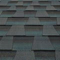 Dark gray asphalt shingle roof with a consistent pattern, featuring overlapping layers.
