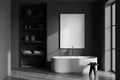 Dark gray bathroom interior with tub, shelves and poster Royalty Free Stock Photo