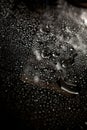 Dark gray and black wet glass background. Water drops on clear surface