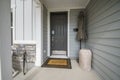 Dark gray front door exterior with lockbox and notes