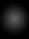 A dark gray gradient background with a soft circular spotlight effect in the center creating a subtle and mysterious abstract Royalty Free Stock Photo