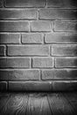 Dark gray grunge textured brick wall and wooden floor Royalty Free Stock Photo